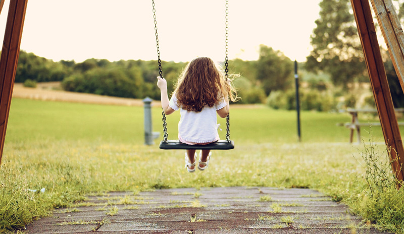 Child playing on swing
