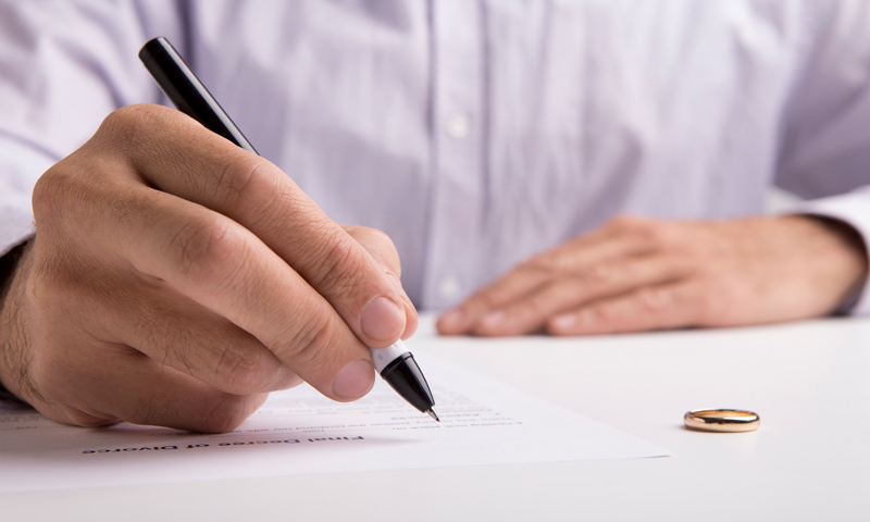 Serve-Divorce-Documents-Blog Man signing divorce papers