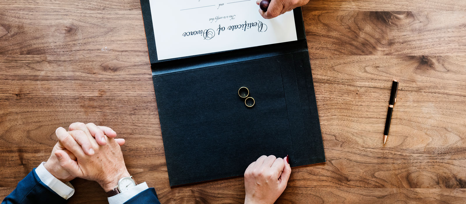 Wedding rings and documents of a divorcing couple.